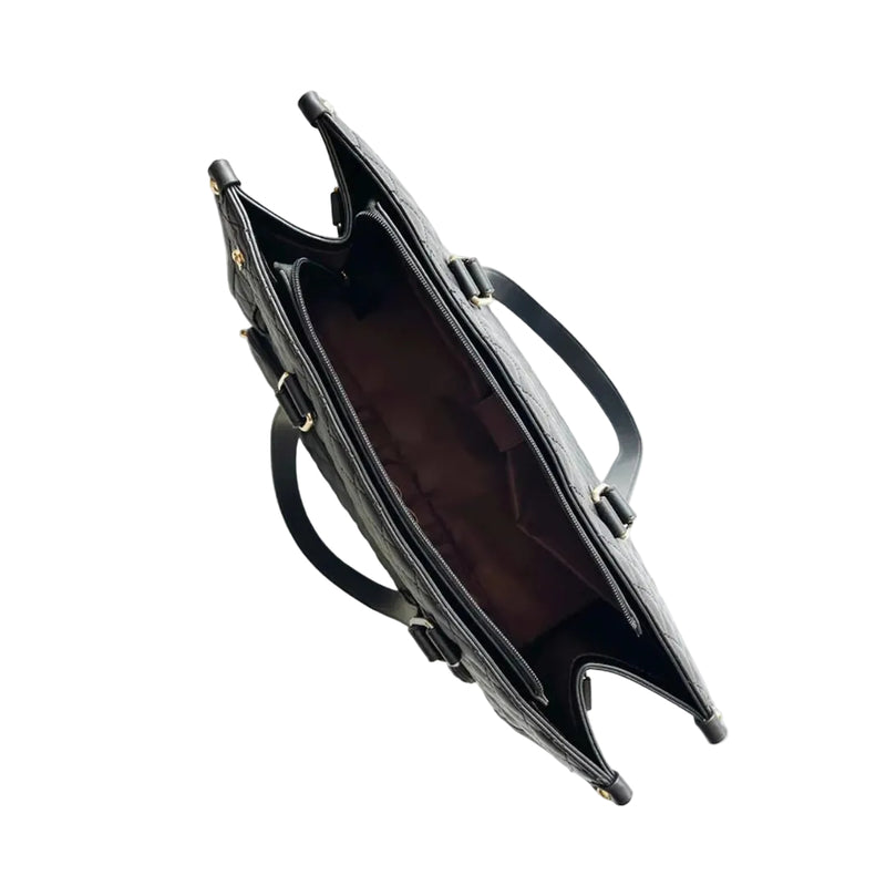 Black handbag with gold accents on a white background